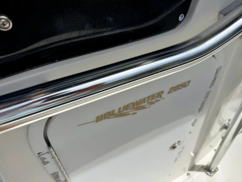 Slide: The Image of 2003 Bluewater Sportfishing 2850 boat detail with logo and chrome railing. - 10