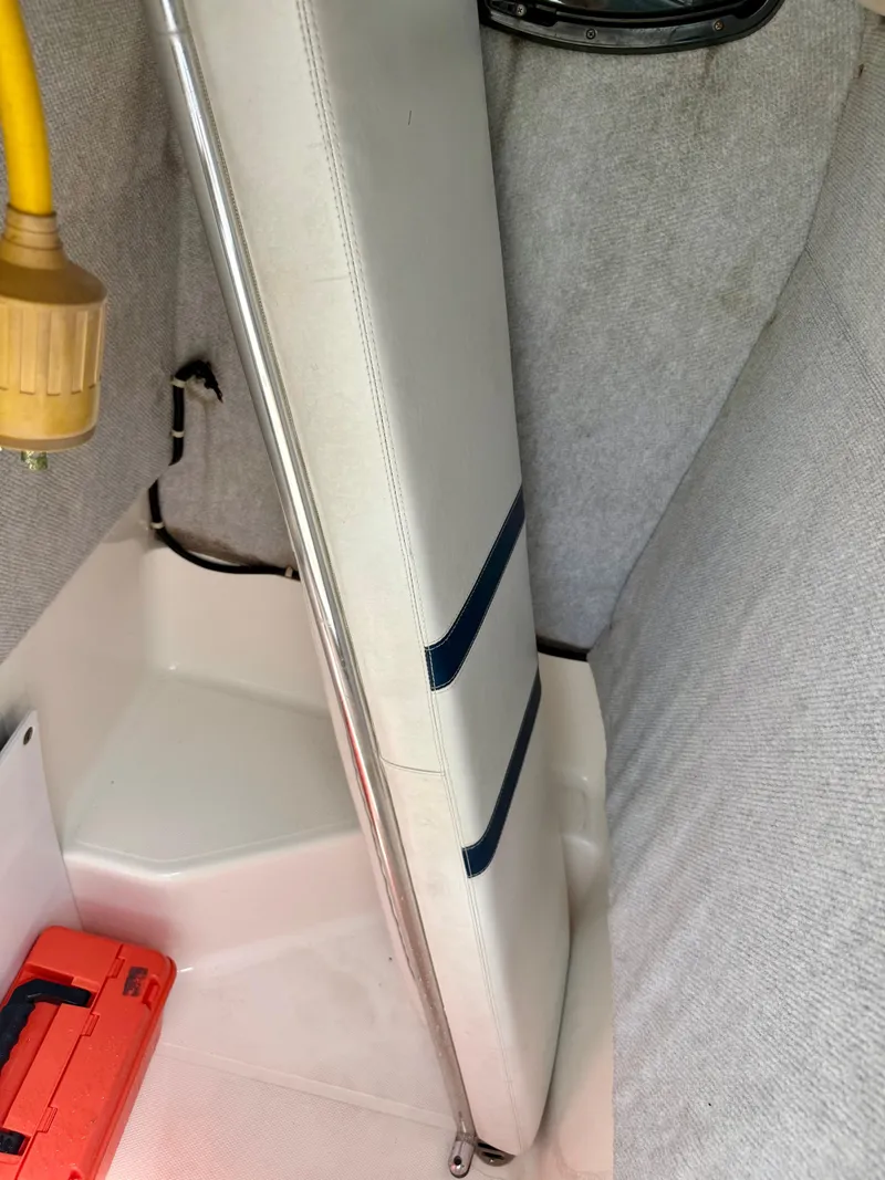 Slide: The Image of Interior of a 2003 Bluewater Sportfishing 2850 boat with seat and storage. - 11