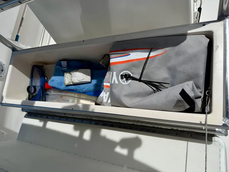 Slide: The Image of Storage compartment on a 2003 Bluewater Sportfishing 2850 boat with fishing gear and equipment. - 13