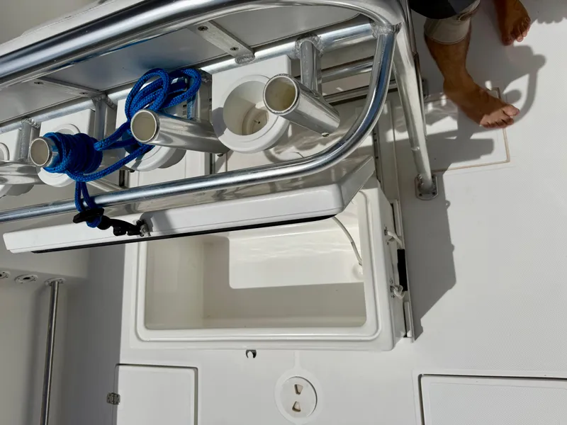 Slide: The Image of 2003 Bluewater Sportfishing 2850 boat deck with rod holders and storage compartment. - 17