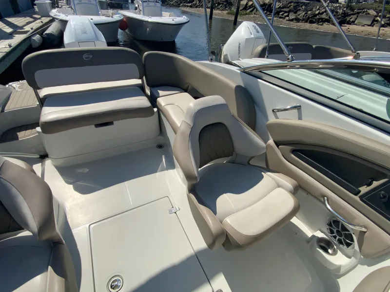 Slide: The Image of 2023 Crownline Eclipse E235 XS boat interior with beige seating and modern design. - 10