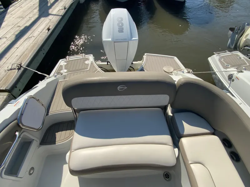 Slide: The Image of 2023 Crownline Eclipse E235 XS boat interior with seating and outboard motor. - 12