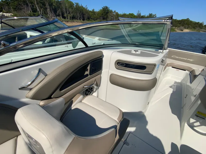 Slide: The Image of 2023 Crownline Eclipse E235 XS boat interior with beige seating and sleek dashboard design. - 6