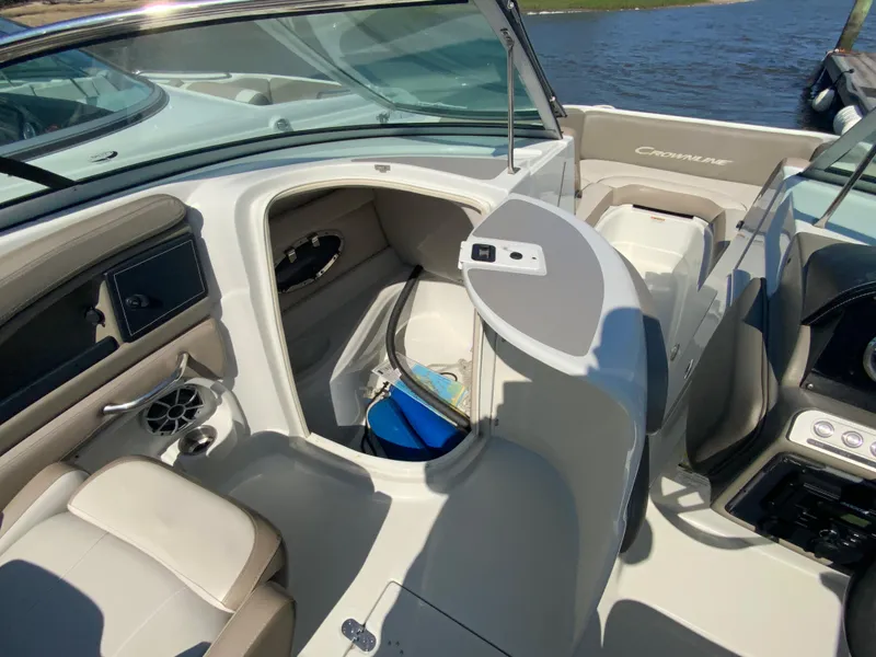 Slide: The Image of 2023 Crownline Eclipse E235 XS boat interior with open storage compartment and seating. - 7