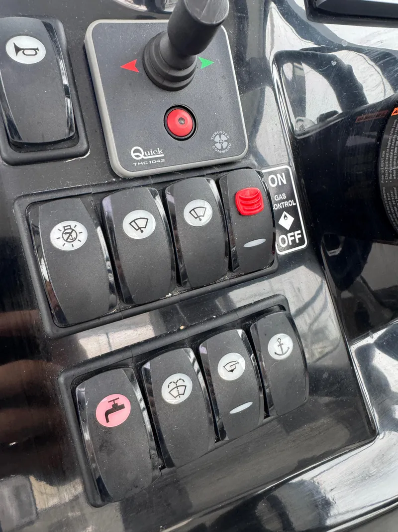 Slide: The Image of Control panel of a 2020 Jeanneau NC Sport 795 boat with various switches. - 11
