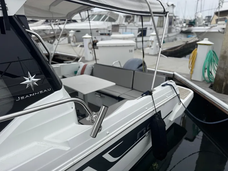 Slide: The Image of 2020 Jeanneau NC Sport 795 boat docked, featuring sleek design and comfortable seating. - 2