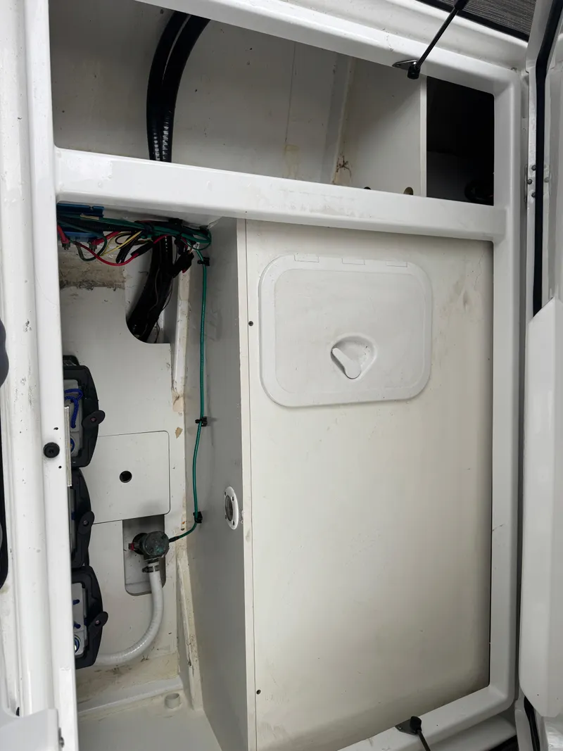 Slide: The Image of 2020 Jeanneau NC Sport 795 boat interior compartment with wiring and storage. - 25