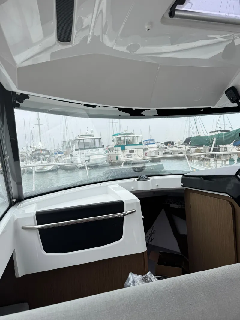 Slide: The Image of Interior view of 2020 Jeanneau NC Sport 795 boat docked at a marina. - 45