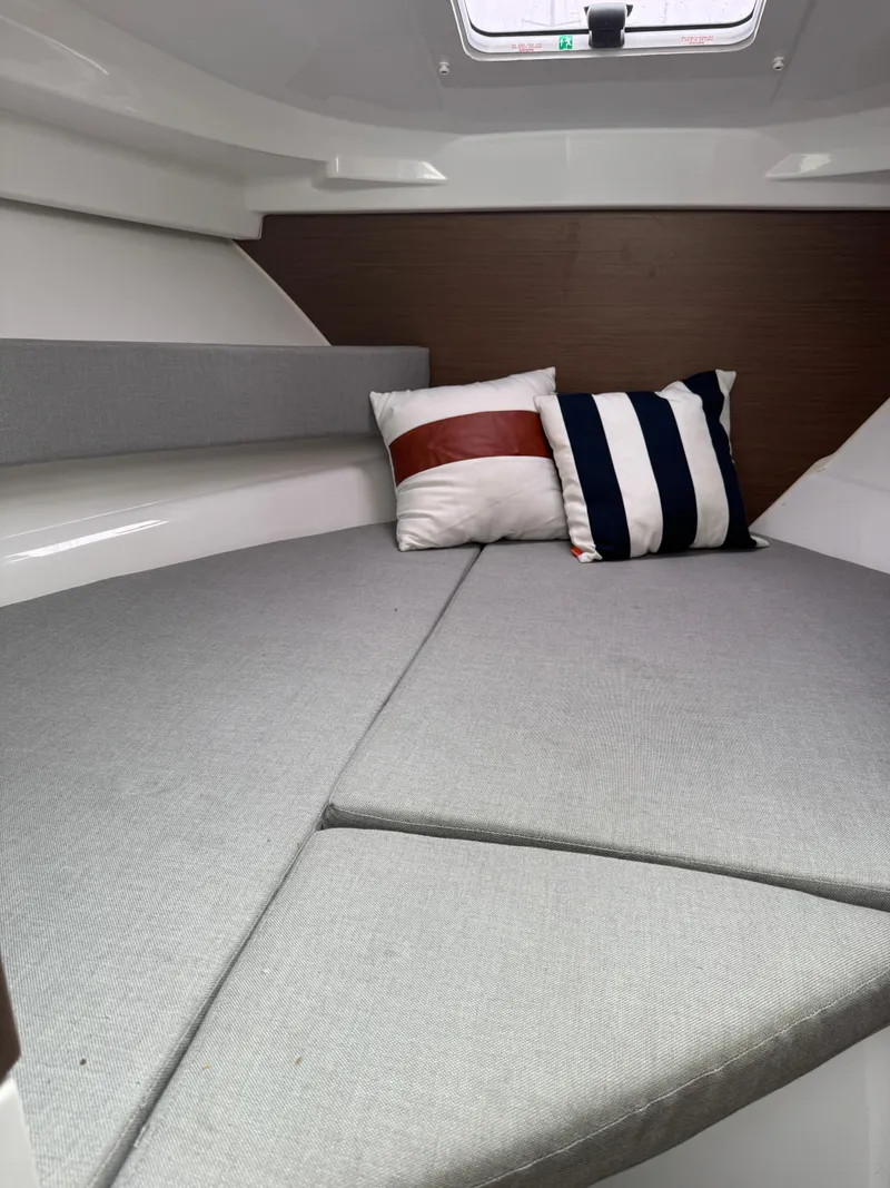 Slide: The Image of Cozy cabin interior of 2020 Jeanneau NC Sport 795 with cushions and pillows. - 47