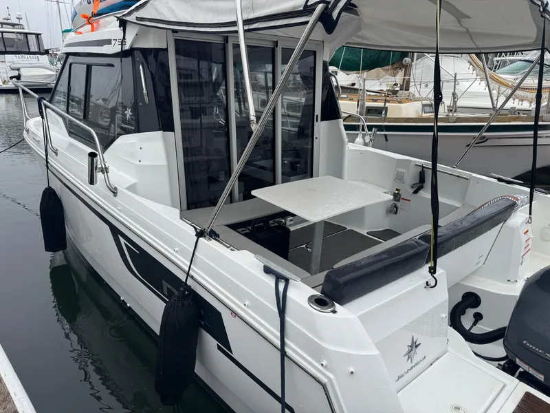 Slide: The Image of 2020 Jeanneau NC Sport 795 boat docked, featuring spacious deck and seating area. - 6