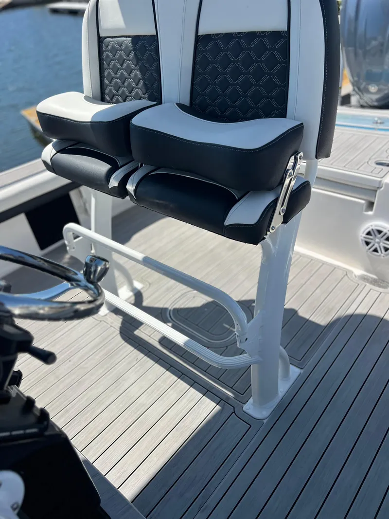 Slide: The Image of 2022 Tidewater 2500 Carolina Bay boat seating with stylish black and white upholstery. - 10