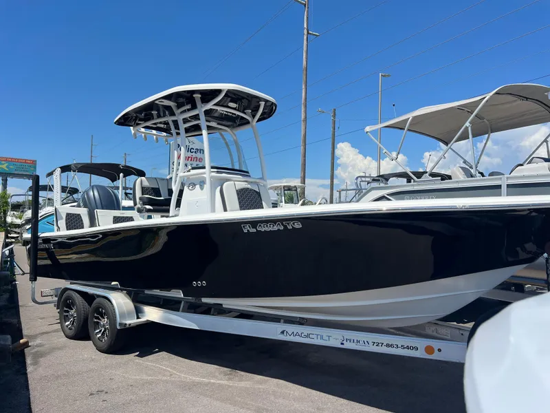 Slide: The Image of 2022 Tidewater 2500 Carolina Bay boat on trailer, black hull, sunny day. - 3