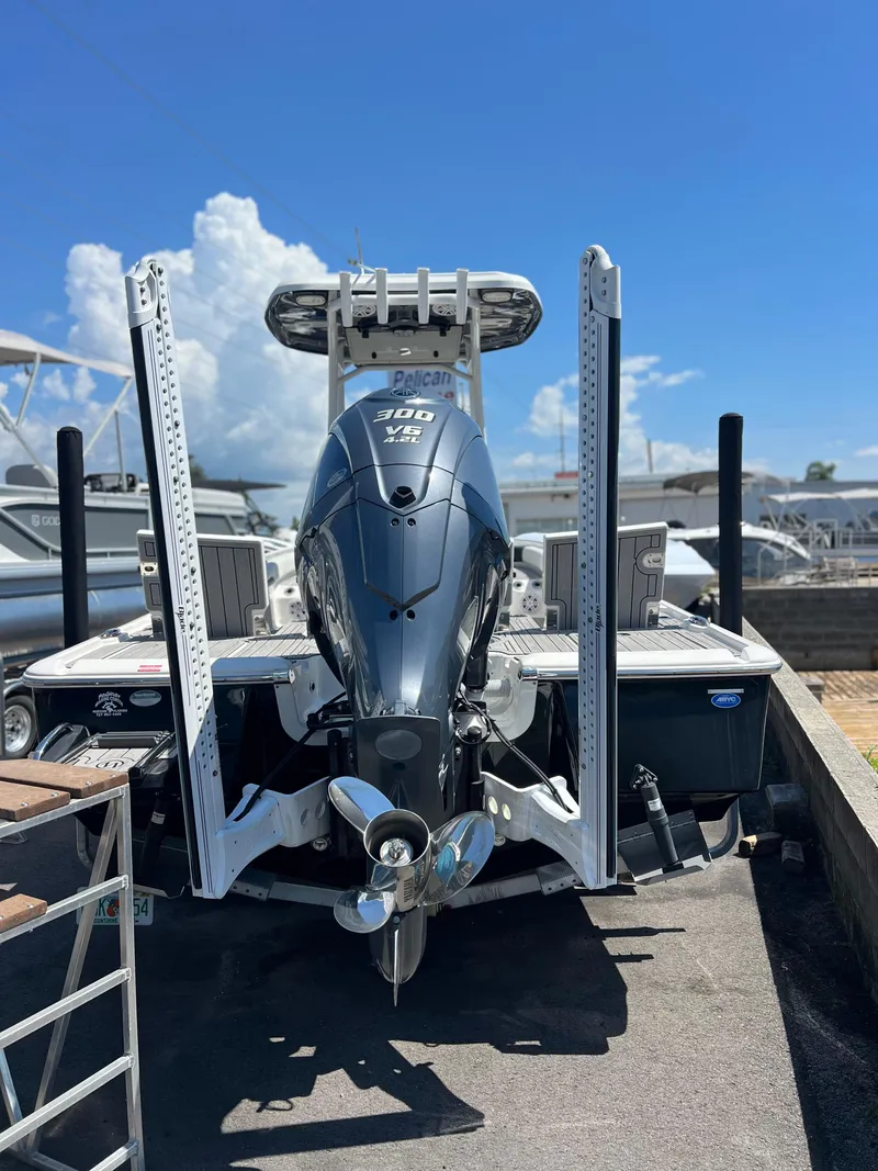 Slide: The Image of 2022 Tidewater 2500 Carolina Bay boat with powerful outboard motor, docked under clear blue sky. - 5