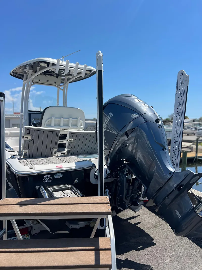 Slide: The Image of 2022 Tidewater 2500 Carolina Bay boat with Yamaha outboard motor, docked under clear blue sky. - 6