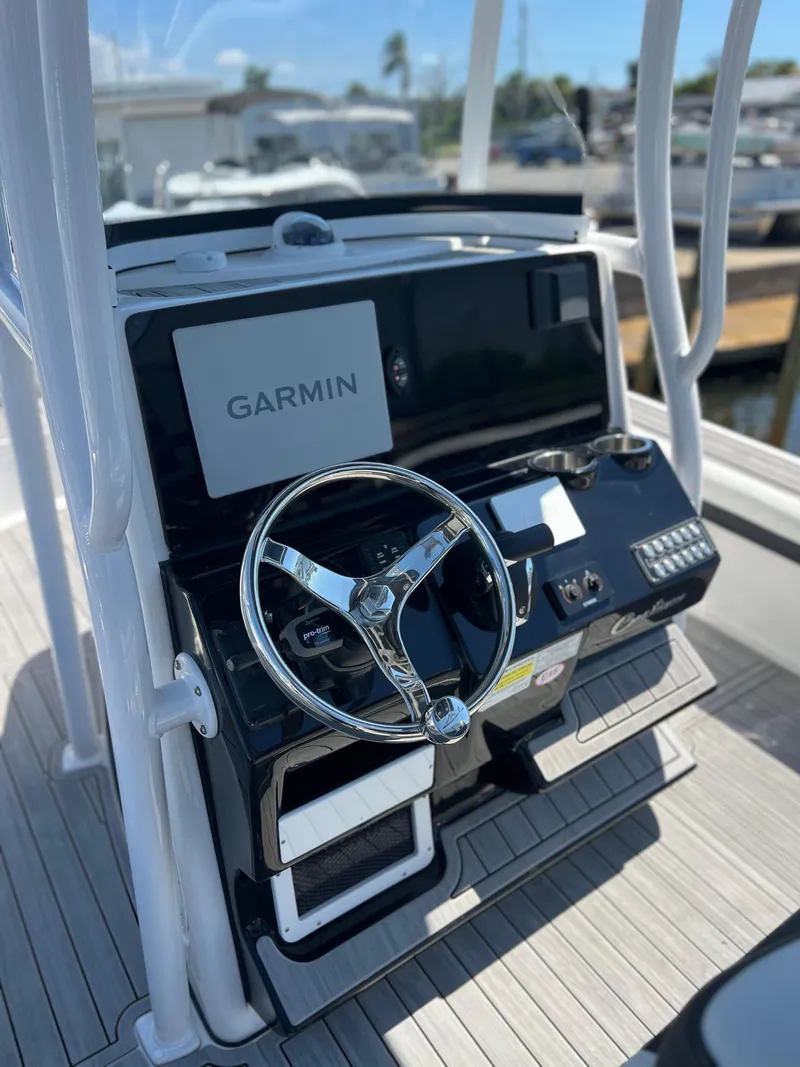 Slide: The Image of 2022 Tidewater 2500 Carolina Bay boat console with Garmin navigation system and steering wheel. - 7