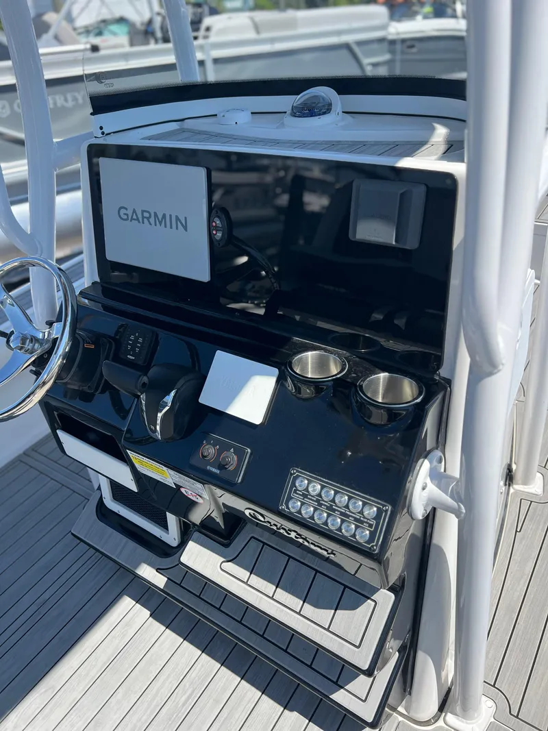 Slide: The Image of 2022 Tidewater 2500 Carolina Bay boat console with Garmin display and dual cup holders. - 8