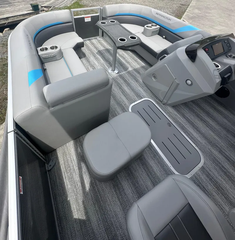 Slide: The Image of 2025 Bennington 22 SXSR pontoon boat interior with gray seating and modern dashboard. - 9