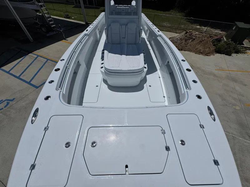 Slide: The Image of 2026 Invincible 33 Catamaran with spacious deck and seating, docked outdoors. - 19