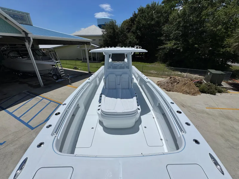 Slide: The Image of 2026 Invincible 33 Catamaran docked, showcasing spacious deck and sleek design. - 20