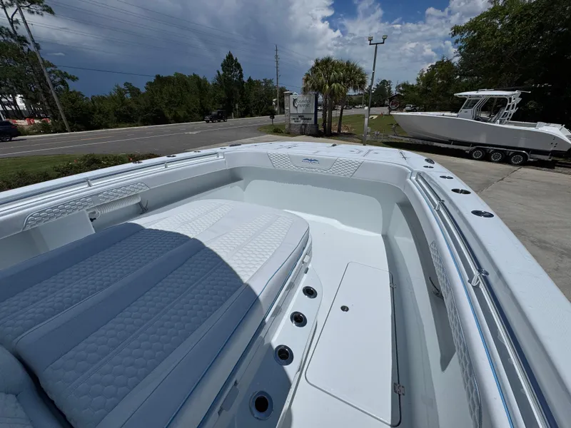 Slide: The Image of 2026 Invincible 33 Catamaran with spacious deck and seating, parked outdoors. - 22