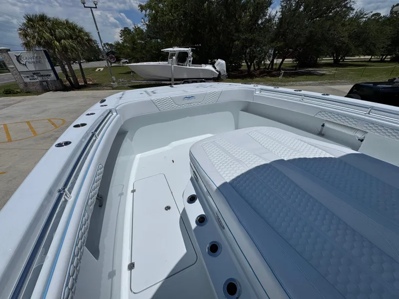 Slide: The Image of 2026 Invincible 33 Catamaran with spacious deck and seating, parked outdoors. - 23