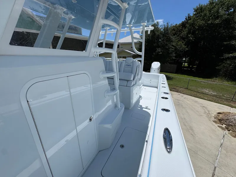 Slide: The Image of 2026 Invincible 33 Catamaran boat deck with seating and storage compartments. - 24