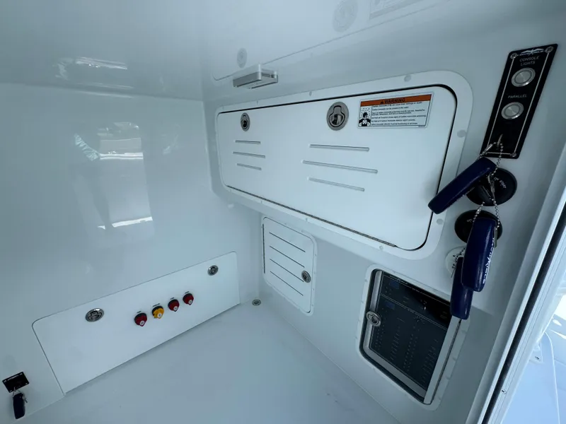 Slide: The Image of Interior control panel of 2026 Invincible 33 Catamaran, featuring switches and storage compartments. - 27