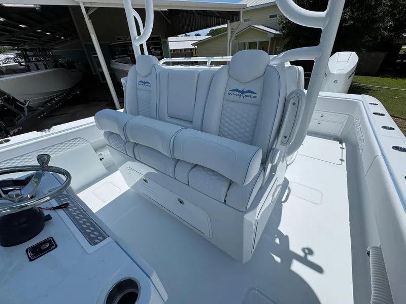 Slide: The Image of 2026 Invincible 33 Catamaran interior with luxurious white seating and steering console. - 28