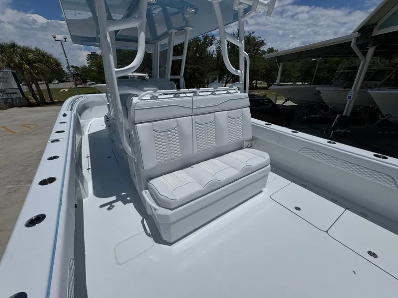 Slide: The Image of 2026 Invincible 33 Catamaran with white seating and spacious deck under a clear sky. - 34