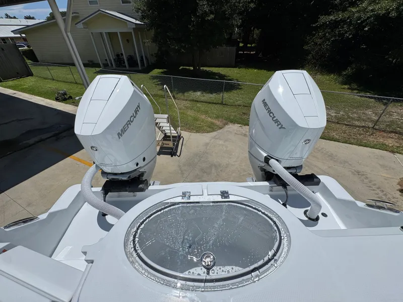 Slide: The Image of 2026 Invincible 33 Catamaran with dual Mercury outboard engines, docked outdoors. - 38