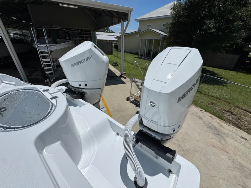 Slide: The Image of 2026 Invincible 33 Catamaran with dual Mercury outboard engines in a sunny outdoor setting. - 39