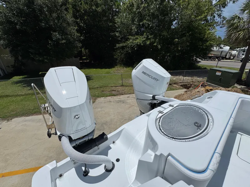 Slide: The Image of 2026 Invincible 33 Catamaran with dual Mercury outboard engines, parked outdoors. - 40