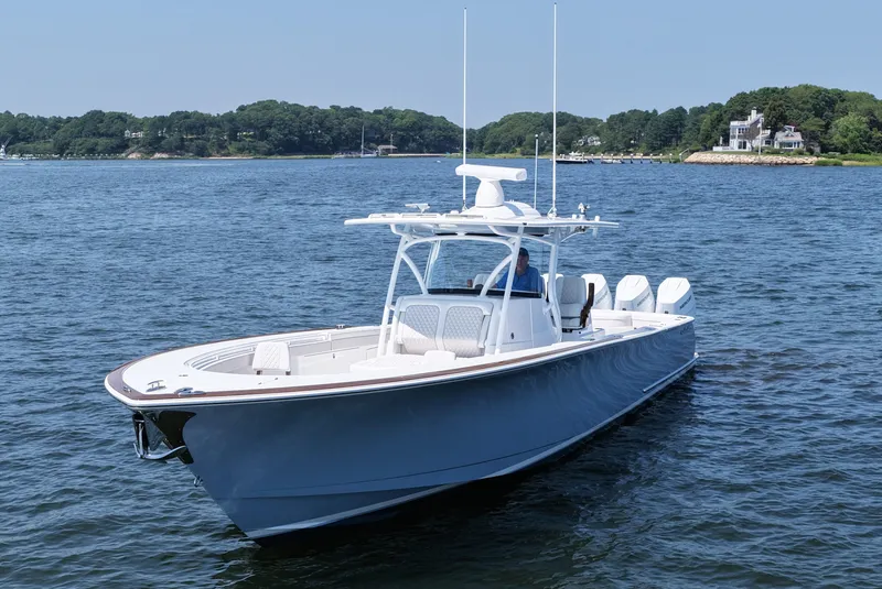 Slide: The Image of 2026 Valhalla Boatworks V-41 cruising on a serene lake with scenic background. - 11