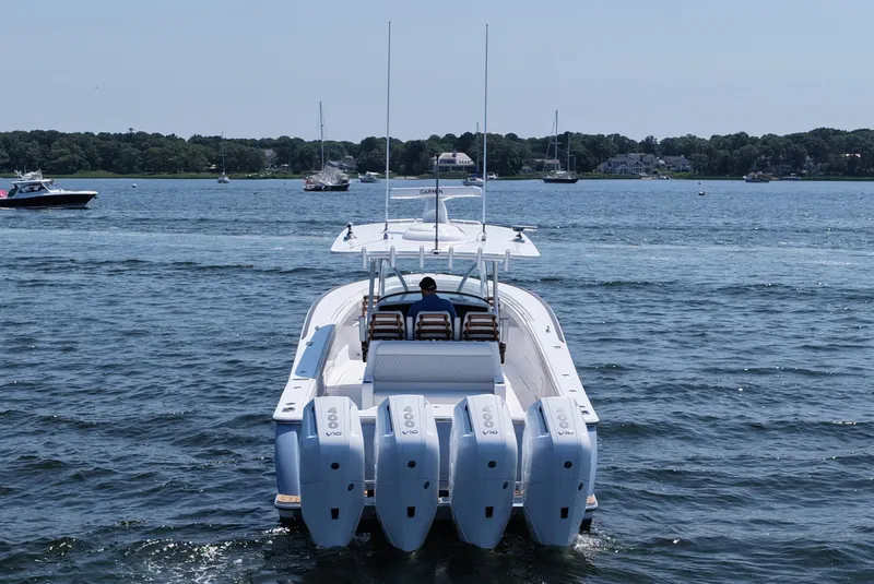 Slide: The Image of 2026 Valhalla Boatworks V-41 cruising on a serene lake with multiple engines. - 5
