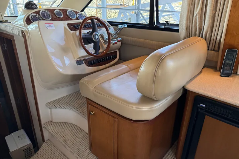Slide: The Image of 2005 Meridian 341 Sedan helm with beige leather seat and wooden dashboard. - 10