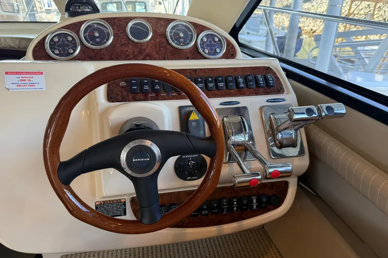 Slide: The Image of 2005 Meridian 341 Sedan helm with wood steering wheel and control panel. - 11