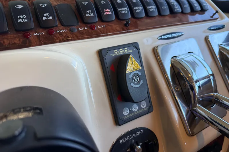 Slide: The Image of Control panel of a 2005 Meridian 341 Sedan boat with various switches and throttle controls. - 12