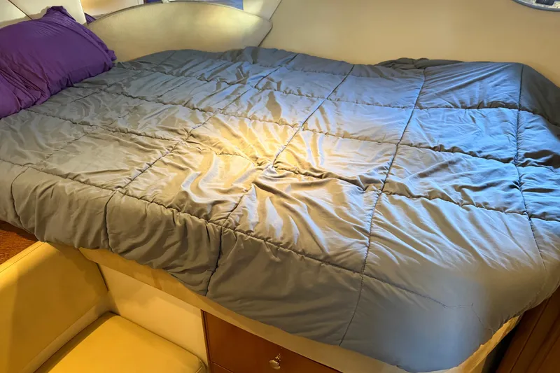 Slide: The Image of Cozy bed inside a 2005 Meridian 341 Sedan yacht cabin with purple pillows. - 15