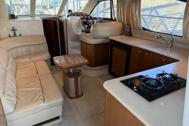 Slide: The Image of Interior of 2005 Meridian 341 Sedan yacht with kitchen, seating, and helm station. - 2