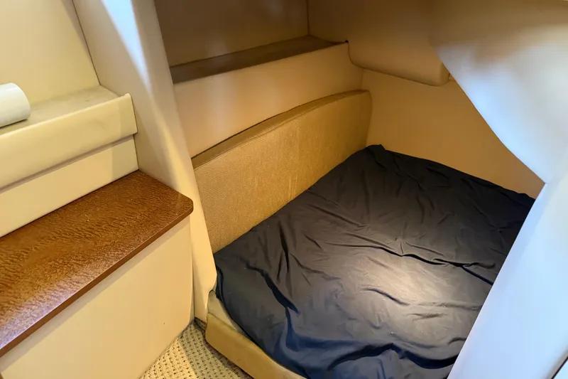 Slide: The Image of 2005 Meridian 341 Sedan cabin interior with cozy sleeping area and wooden accents. - 23