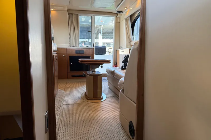 Slide: The Image of Interior of 2005 Meridian 341 Sedan yacht, featuring cozy seating and elegant wood finishes. - 25