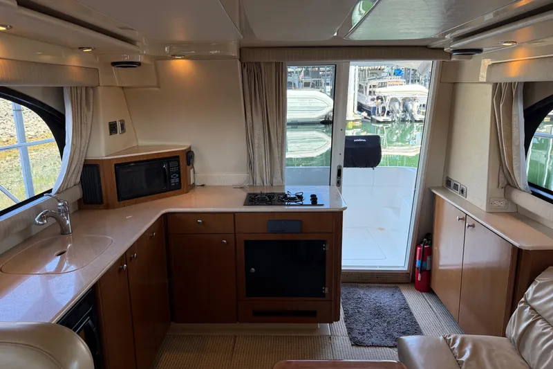 Slide: The Image of Interior of a 2005 Meridian 341 Sedan yacht with kitchen and marina view. - 26