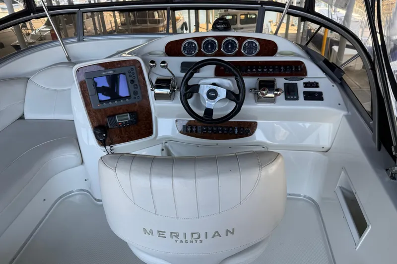Slide: The Image of Cockpit of 2005 Meridian 341 Sedan yacht with steering wheel and navigation controls. - 29