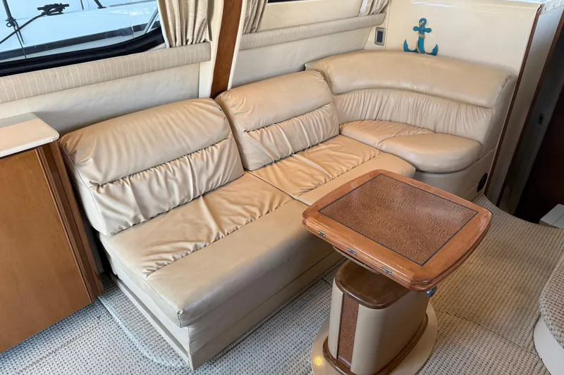 Slide: The Image of Interior of 2005 Meridian 341 Sedan with beige leather seating and wooden table. - 3