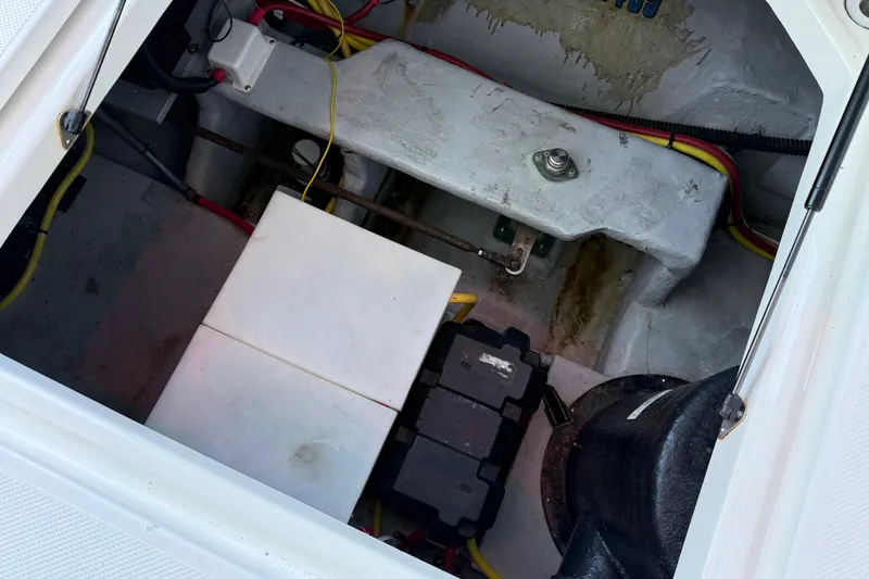 Slide: The Image of Engine compartment of a 2005 Meridian 341 Sedan boat, showing wiring and battery setup. - 45