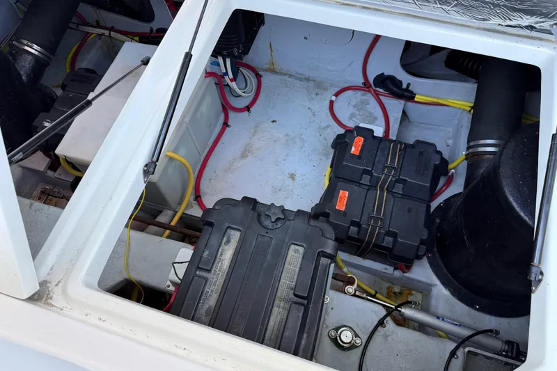 Slide: The Image of Engine compartment of a 2005 Meridian 341 Sedan with visible wiring and battery setup. - 46