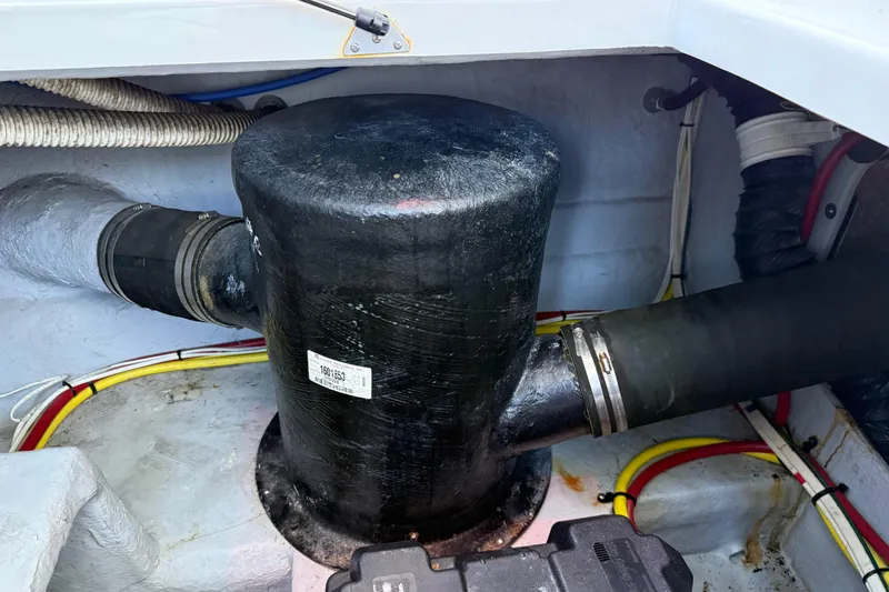 Slide: The Image of Engine compartment of a 2005 Meridian 341 Sedan with visible hoses and wiring. - 49