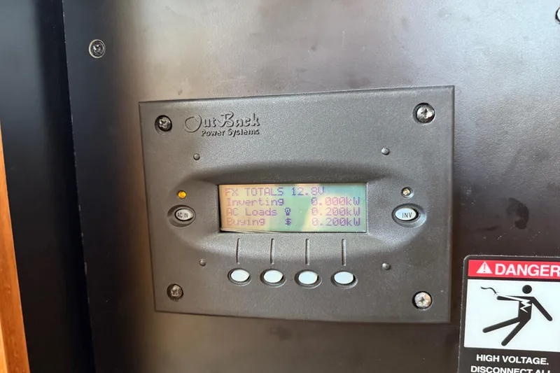 Slide: The Image of OutBack Power Systems display on 2005 Meridian 341 Sedan, showing power metrics and warning label. - 52