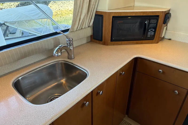 Slide: The Image of 2005 Meridian 341 Sedan kitchen with sink, microwave, and wooden cabinetry. - 6