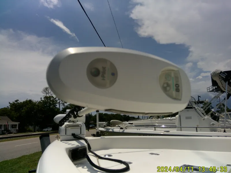 Slide: The Image of 2017 NauticStar 2140 Sport boat with trolling motor under a partly cloudy sky. - 10